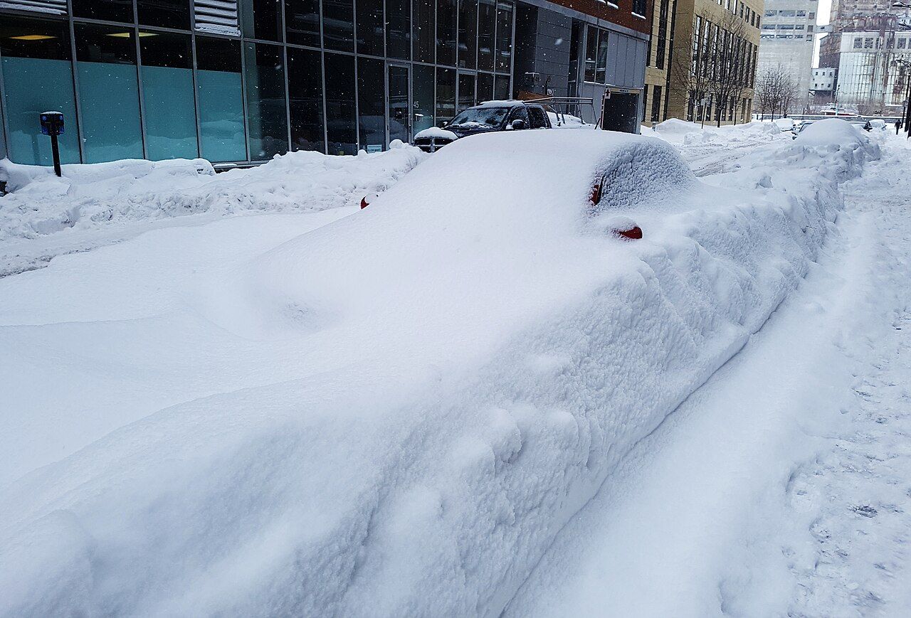 A car buried in snow on a Montreal street after a blizzard